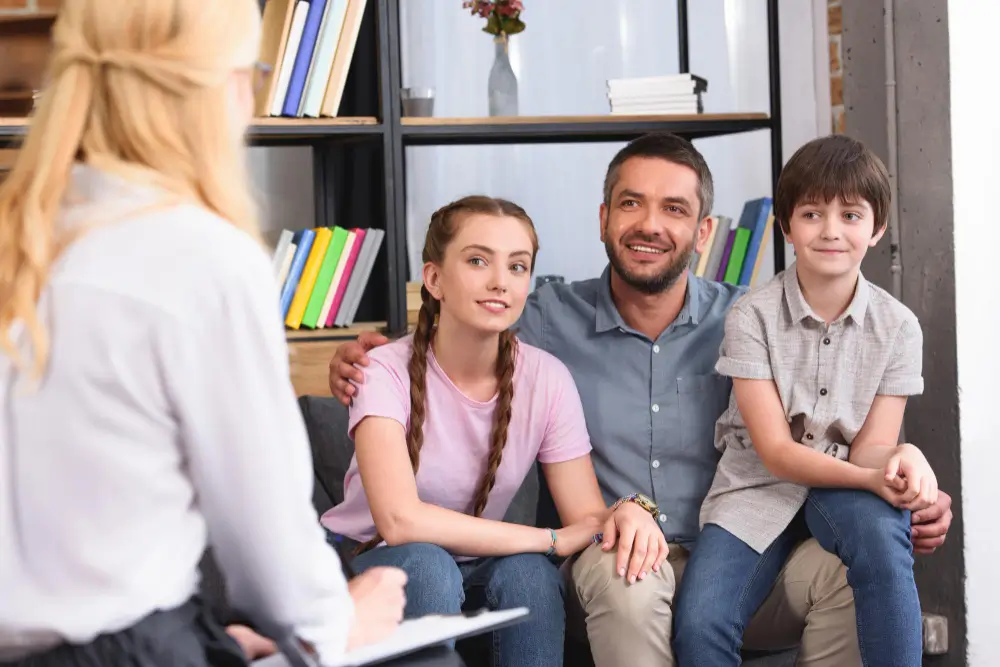 female counselor-therapy session in Houston with happy family